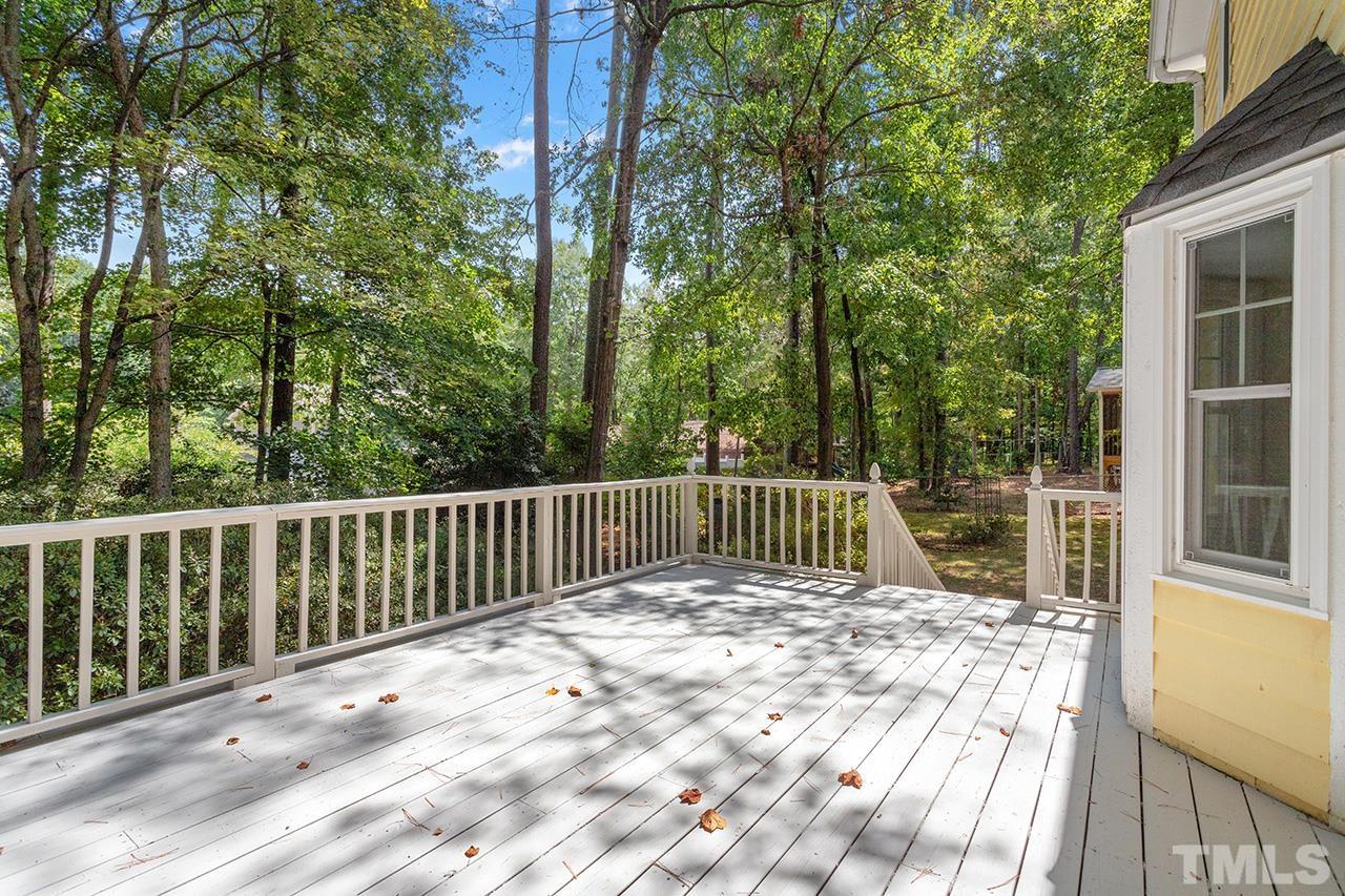 7416 Old Fox Trail Raleigh, NC 27613 - Photo 6 of 26 a view of balcony with wooden floor and fence