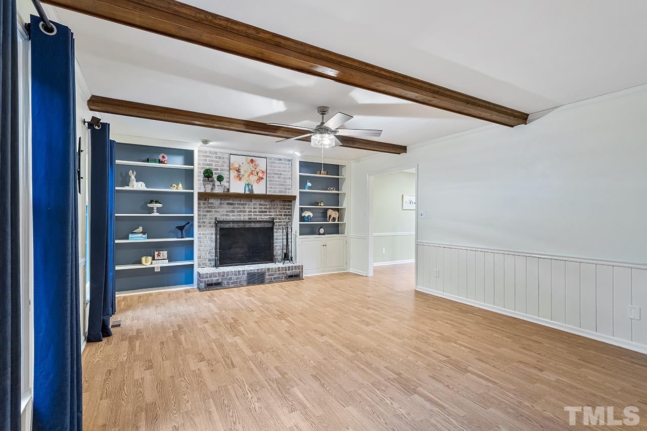 7416 Old Fox Trail Raleigh, NC 27613 - Photo 9 of 26 a view of an empty room with a fireplace and a window