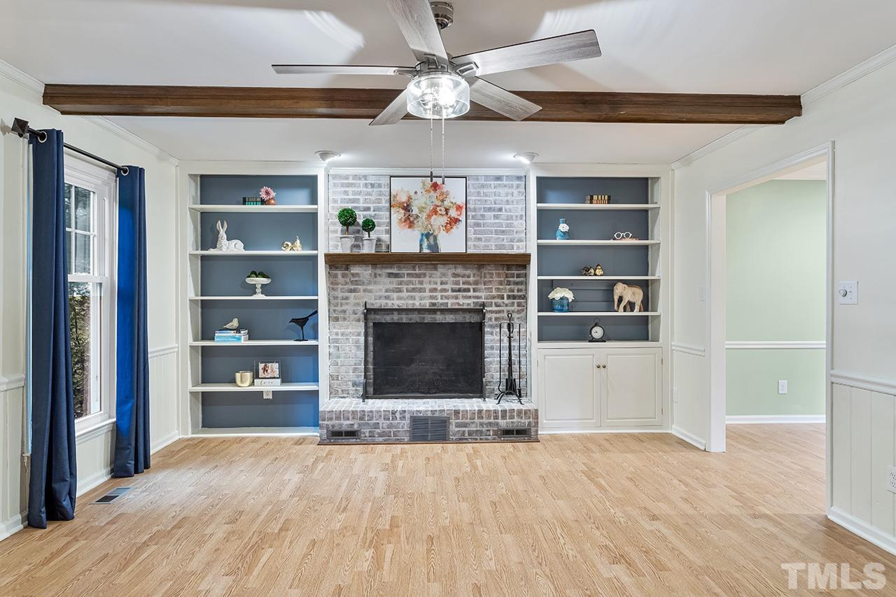 7416 Old Fox Trail Raleigh, NC 27613 - Photo 10 of 26 a view of an empty room with a fireplace and a window