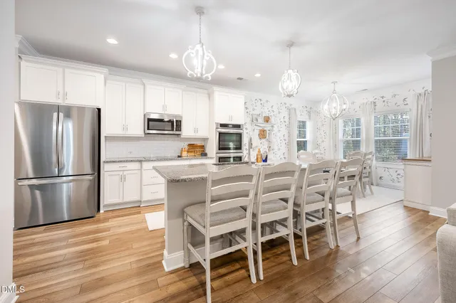 a view of a dining room with furniture wooden floor and chandelier