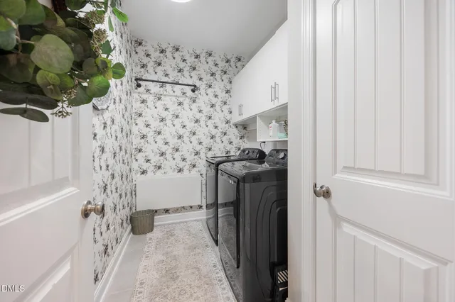 a kitchen with stainless steel appliances a dining table chairs stove refrigerator and cabinets