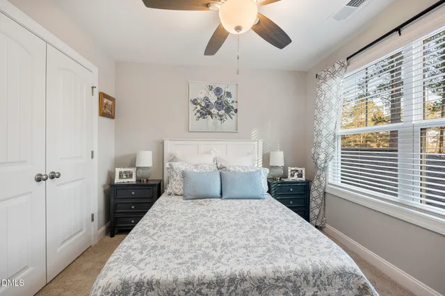 a living room with furniture a flat screen tv and a table