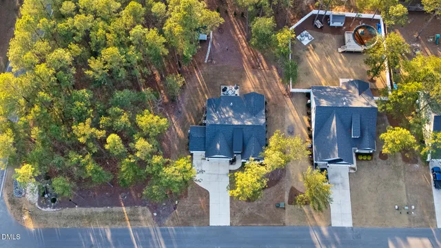 a view of a house with a yard and potted plants