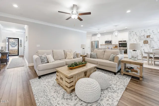 a view of a hallway with wooden floor and stairs