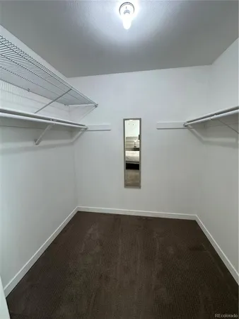 a view of a room with rack on the wall and a window