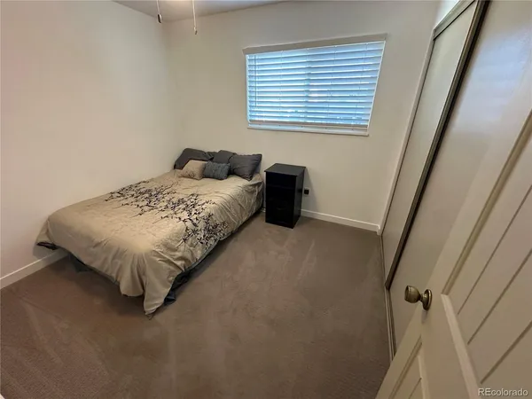 a bed sitting in a bedroom next to a window
