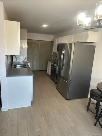 a kitchen with refrigerator and window