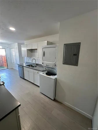 a kitchen with a sink and a stove top oven