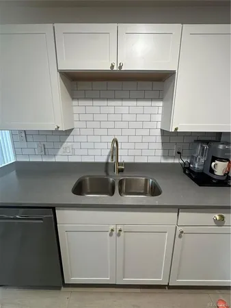 a kitchen with a sink and cabinets