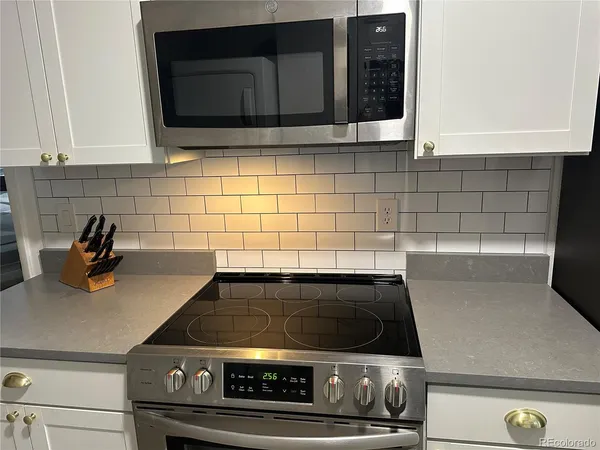 a stove top oven sitting inside of a kitchen