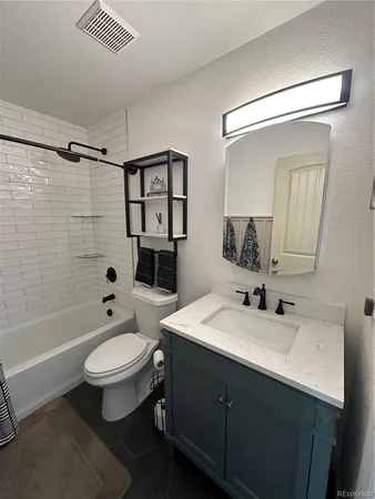 a bathroom with a sink a toilet a mirror and shower