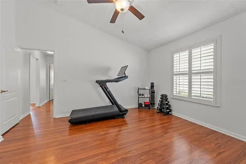 a living room with a gym equipment and a large window
