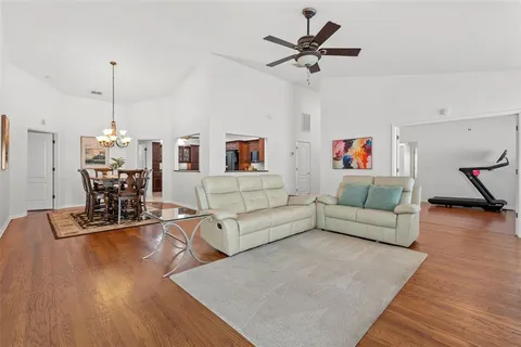 a living room with furniture and a wooden floor
