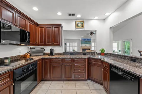 a kitchen with a sink stove top oven and microwave