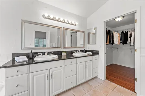 a bathroom with double sink and a mirror