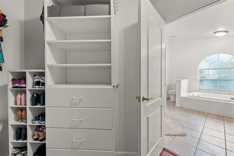 a view of walk in closet with empty racks
