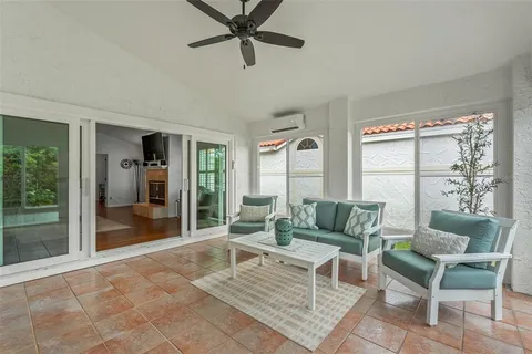 a living room with furniture and a floor to ceiling window