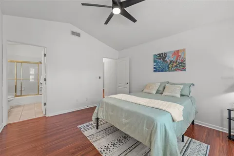 a bedroom with a bed and a painting on the wall