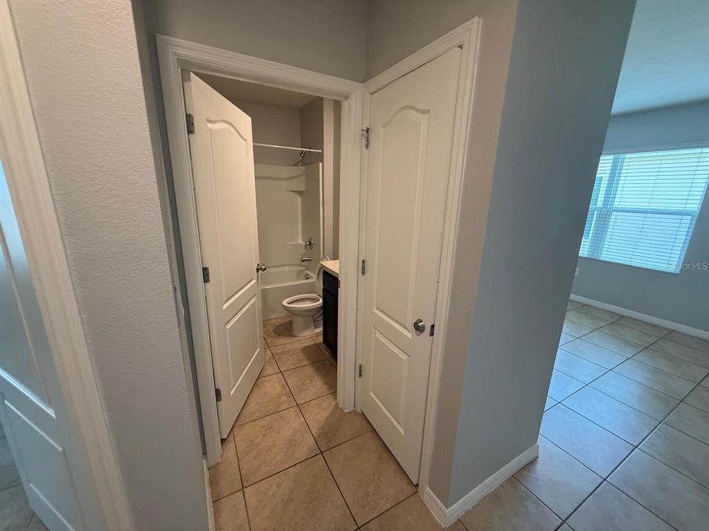 754 Chinoy Road Davenport, FL 33837 - Photo 11 of 26 a bathroom with a sink a toilet and a shower
