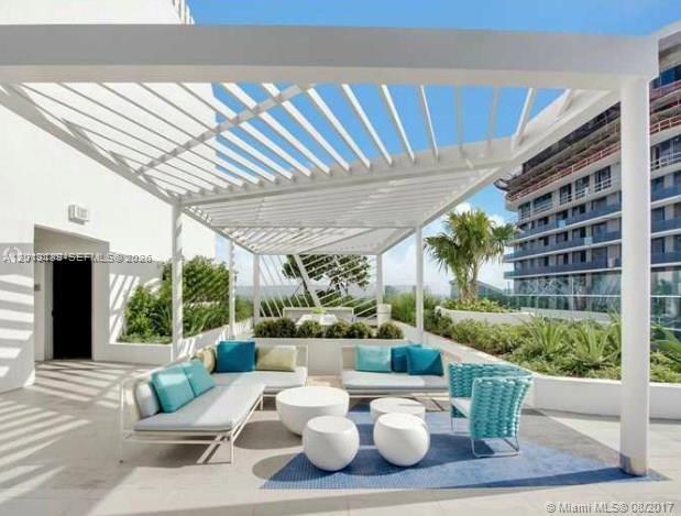 45 Southwest 9th Street, Unit 1907 Miami, FL 33130 - Photo 15 of 16 a outdoor living space with furniture and garden view
