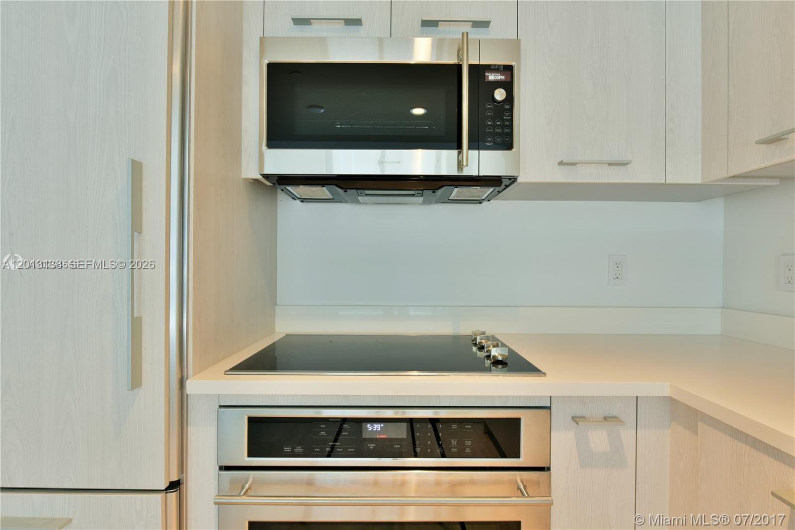 45 Southwest 9th Street, Unit 1907 Miami, FL 33130 - Photo 3 of 16 a stove top oven sitting inside of a kitchen