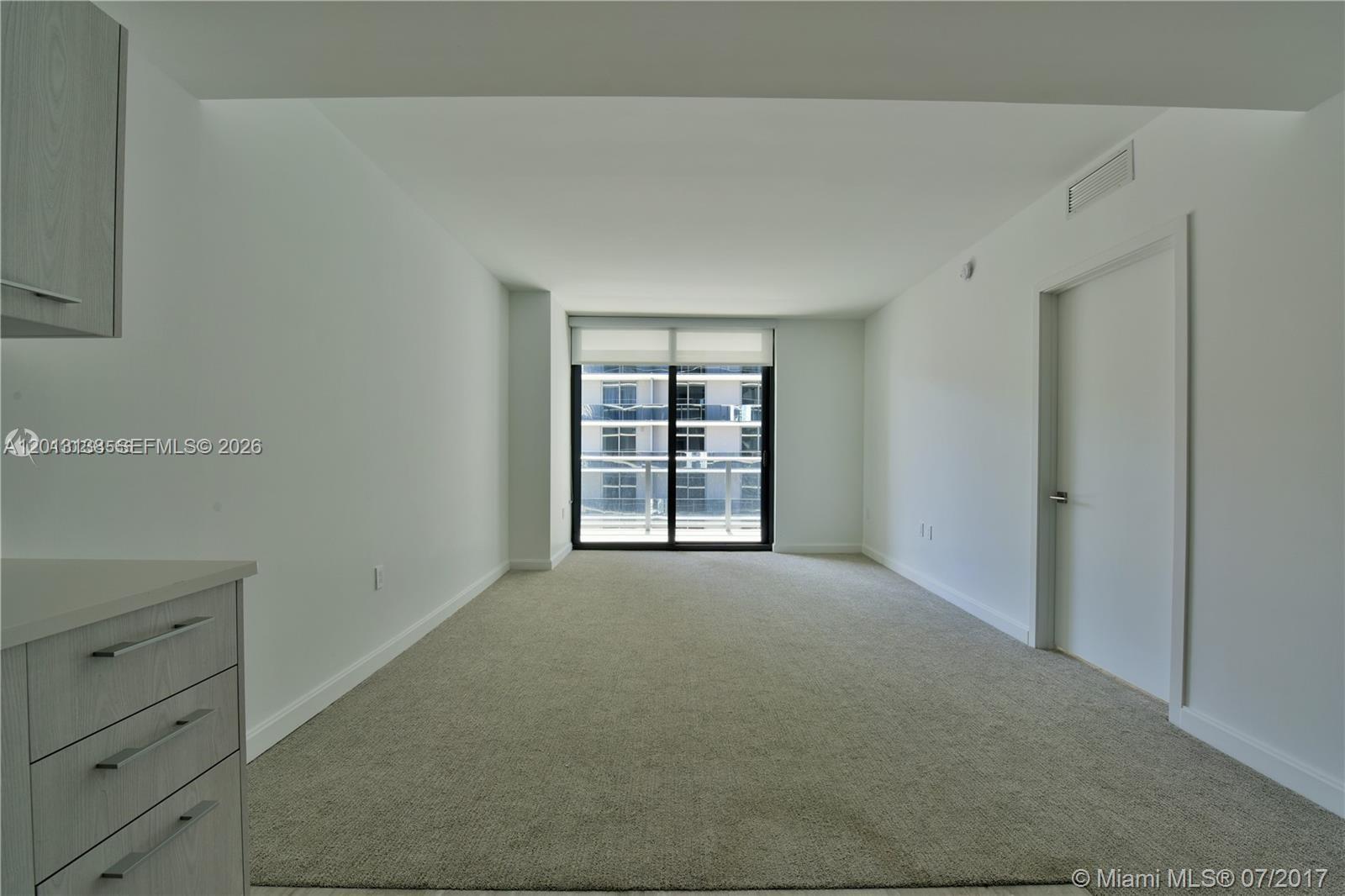 45 Southwest 9th Street, Unit 1907 Miami, FL 33130 - Photo 4 of 16 a view of an empty room with a window
