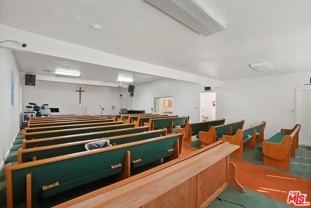 a living room with furniture and a pool table