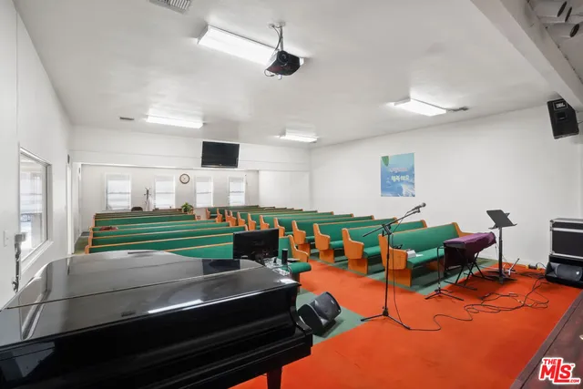 a room with furniture a bookshelf and a window