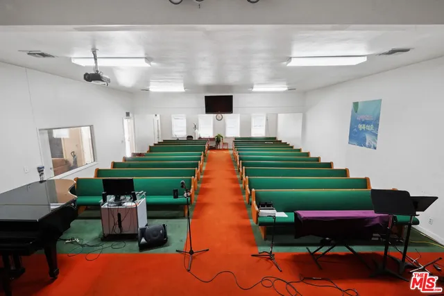a living room with furniture and a book shelf