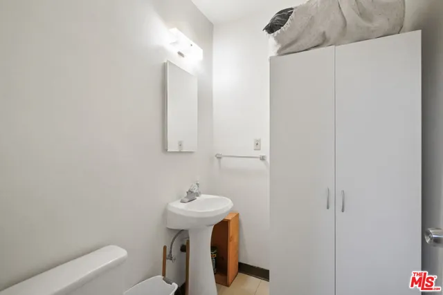 a room with stainless steel appliances kitchen island a refrigerator and a stove