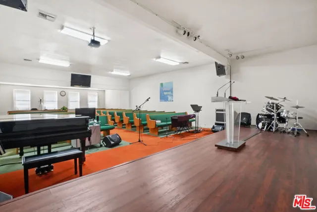 a bathroom with a sink a toilet a mirror and shower