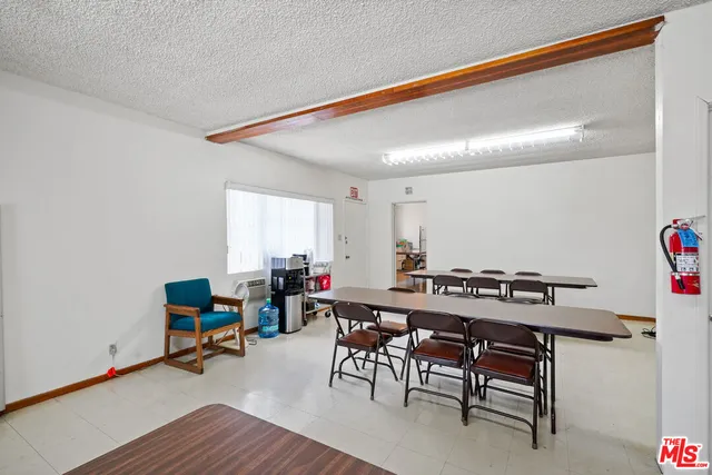 a view of a house with a patio and a yard