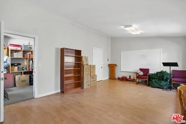 an aerial view of residential houses with outdoor space and parking