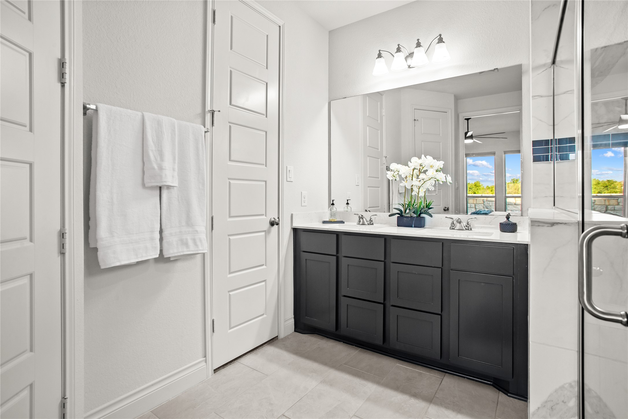 369 Cold Riv Run Kyle, TX 78640 - Photo 14 of 40 Full bath featuring double vanity, a large walk in shower and a walk-in closet.