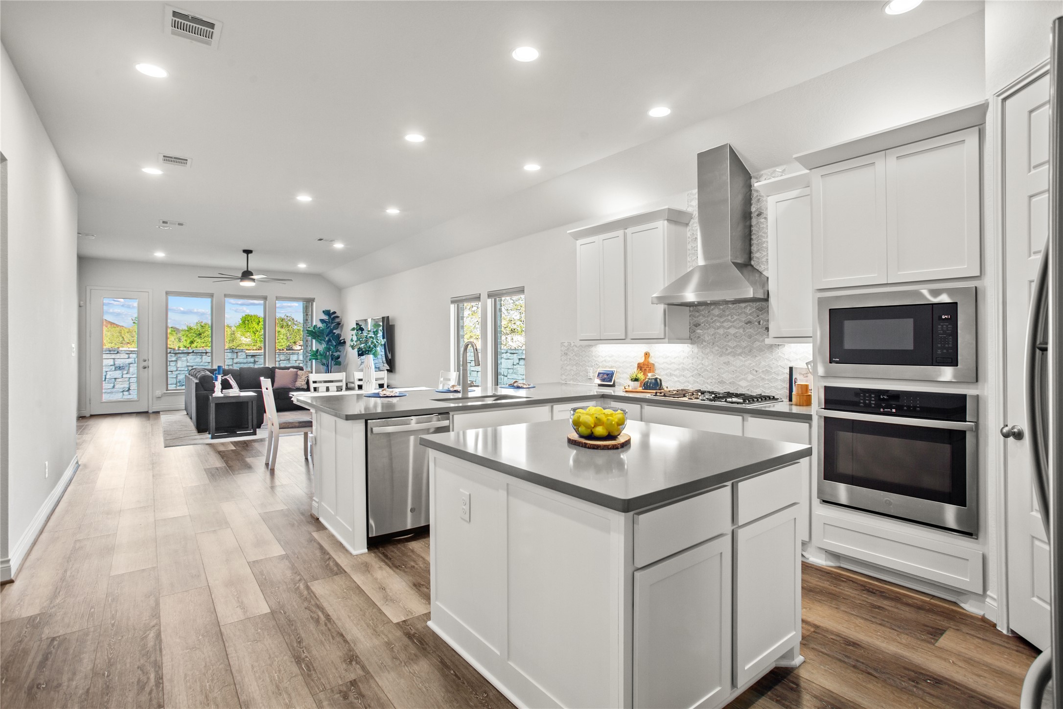 369 Cold Riv Run Kyle, TX 78640 - Photo 40 of 40 Kitchen with a peninsula, open floor plan, white cabinetry, stainless steel appliances, and recessed lighting