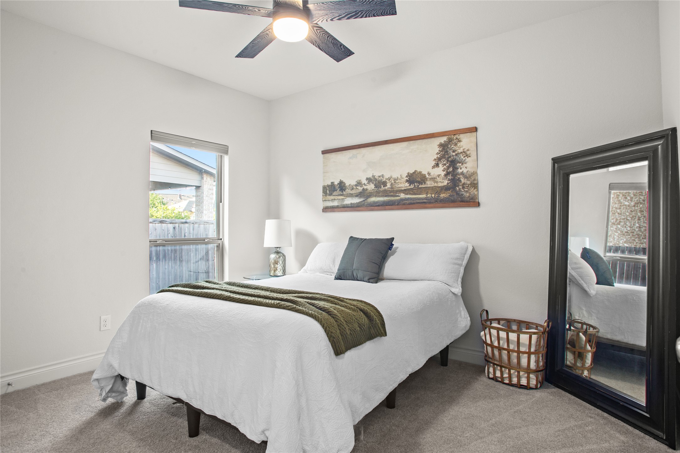 369 Cold Riv Run Kyle, TX 78640 - Photo 9 of 40 Secondary bedroom with light carpet and ceiling fan.