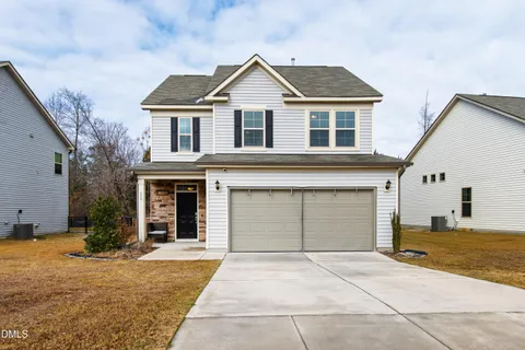 a front view of a house with a yard and garage