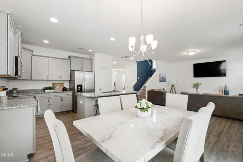 a large kitchen with a table and chairs