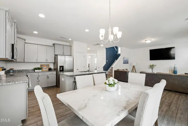 a large kitchen with a table and chairs