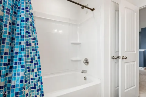 a view of a house with a patio and a yard