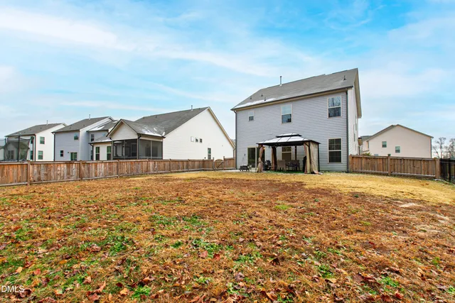 a view of swimming pool with table and chairs under an umbrella