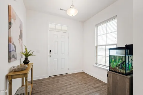 a view of an entryway with wooden floor