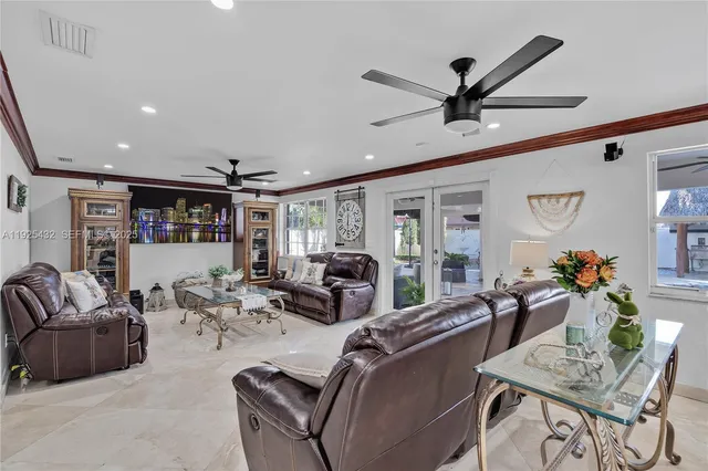 a living room with furniture and a ceiling fan