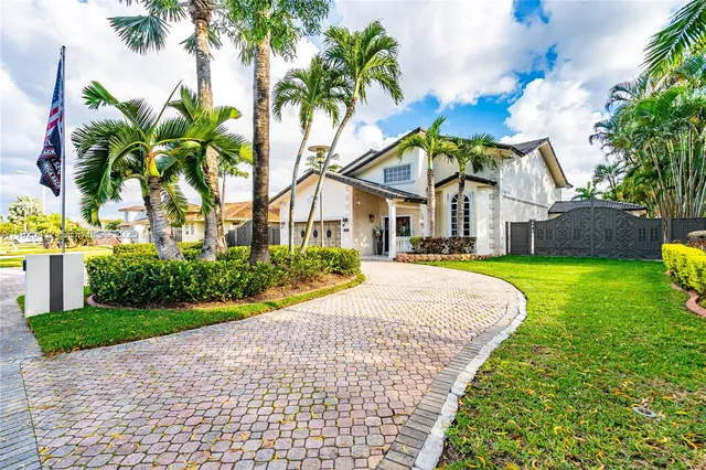 a front view of house with yard and green space