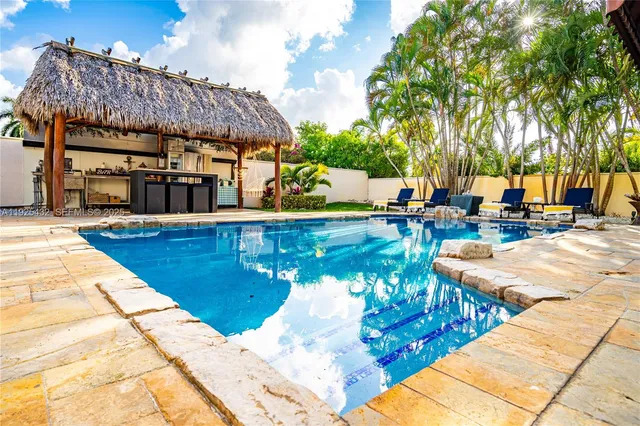an aerial view of residential houses with outdoor space and trees