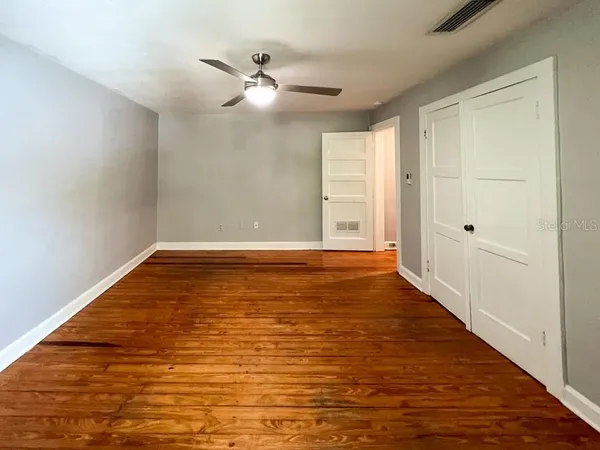 a view of room with window and wooden floor