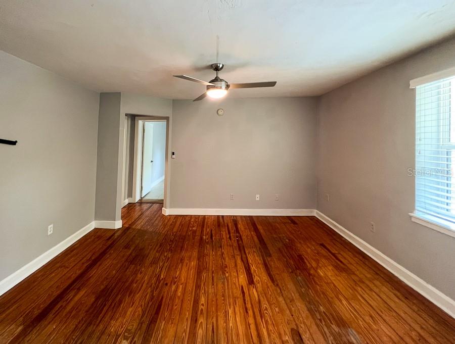 204 Northwest 18th Street, Unit 4 Gainesville, FL 32603 - Photo 20 of 20 wooden floor in an empty room with a window