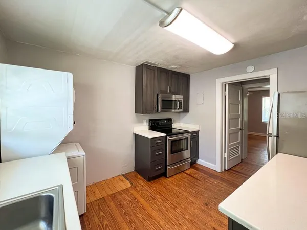 a kitchen with a stove a refrigerator and a sink