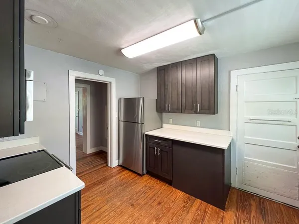 a kitchen with stainless steel appliances kitchen island sink refrigerator and stove