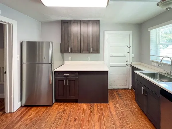 a kitchen with a refrigerator and a sink